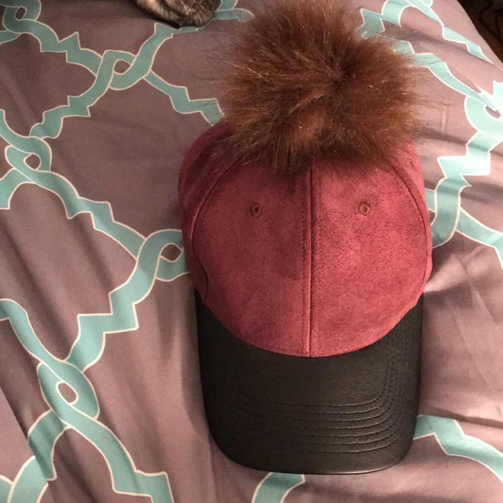 Burgundy Snapback with a brown puffball on top